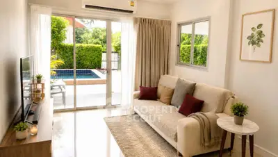 Bright living room with pool view, cozy sofa, and modern decor