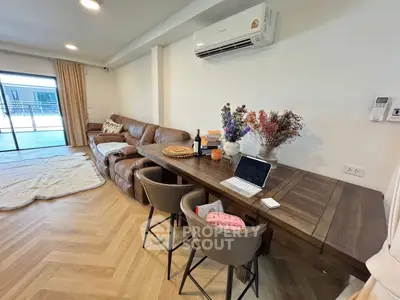 Spacious living room with modern decor and balcony access