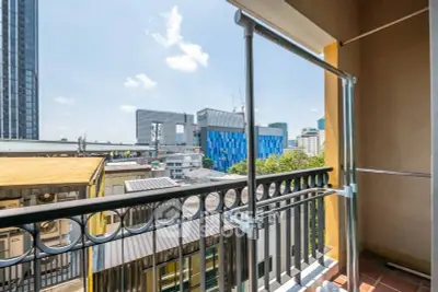 Charming urban balcony with cityscape view, ideal for relaxation and enjoying the skyline.