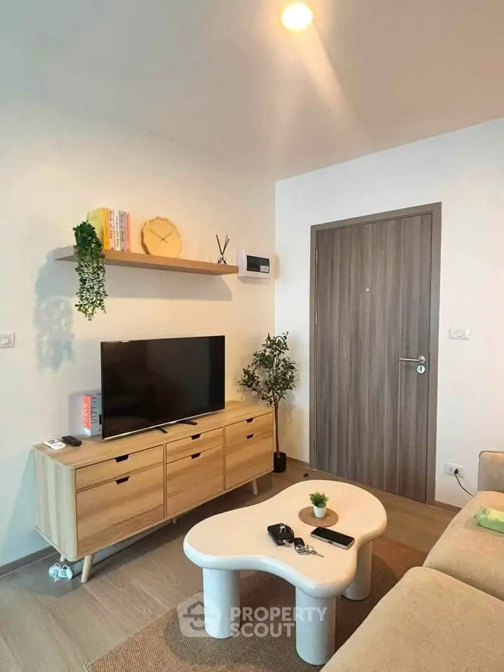 Modern living room with stylish furniture and TV setup, perfect for cozy relaxation.