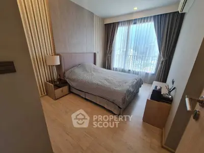 Modern bedroom with large window and stylish decor in urban apartment