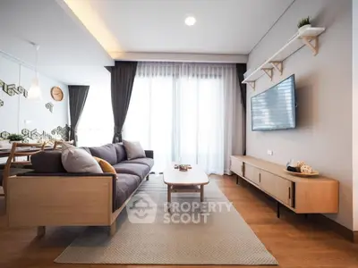 Modern living room with stylish furniture and natural light, perfect for relaxation and entertainment.