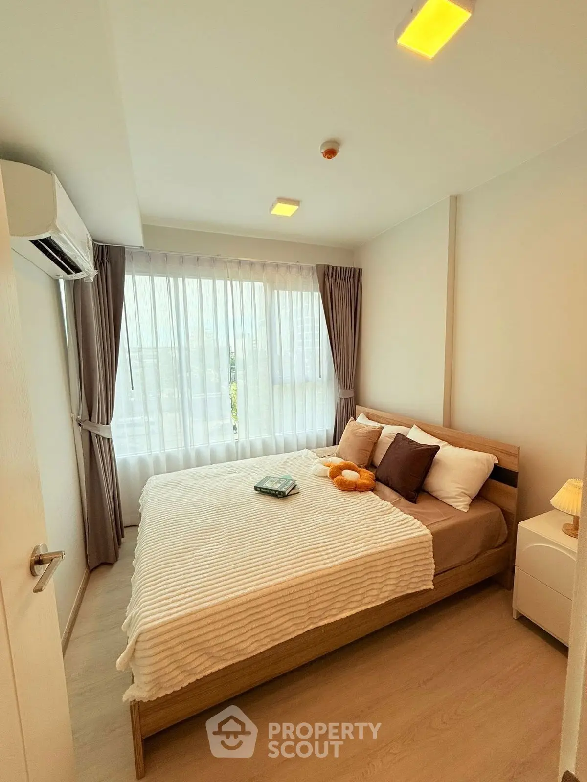 Cozy bedroom with large window and modern decor