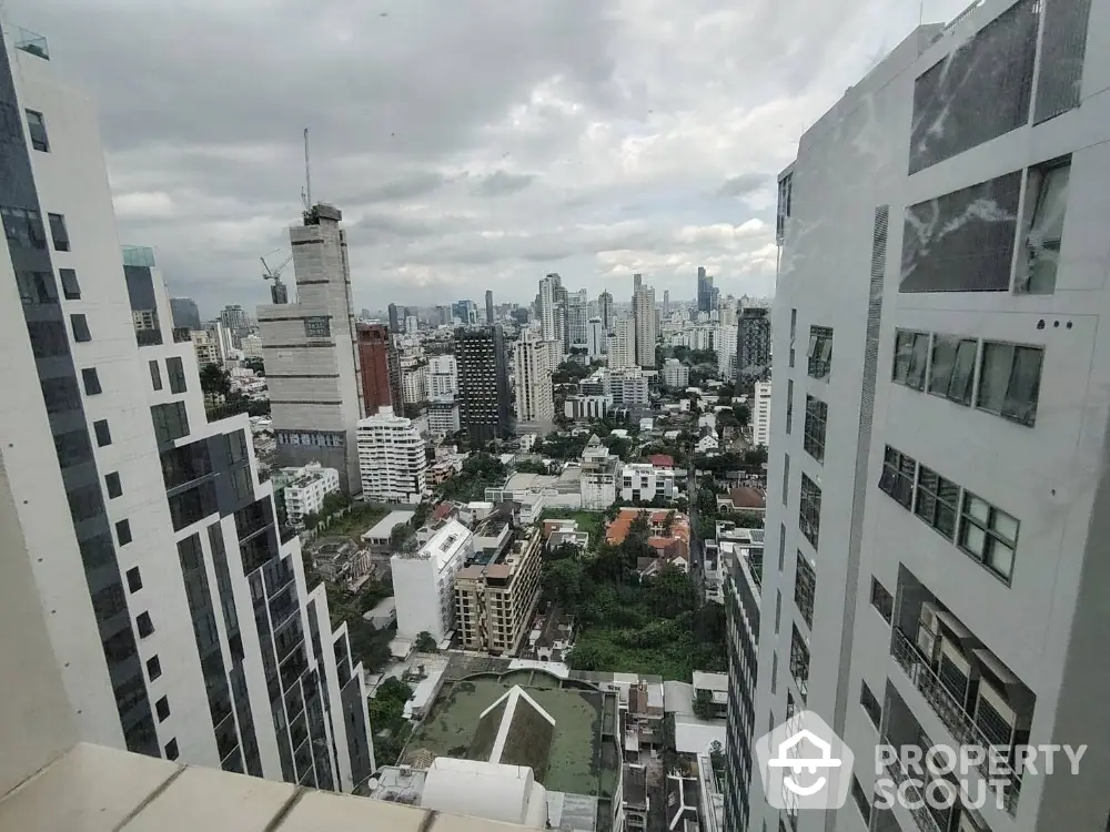 Stunning cityscape view from high-rise apartment balcony in urban skyline.