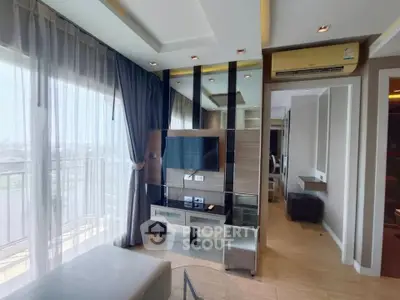 Modern living room with large windows and stylish decor in a high-rise apartment.