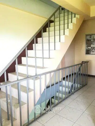Spacious stairwell with modern railing in a residential building