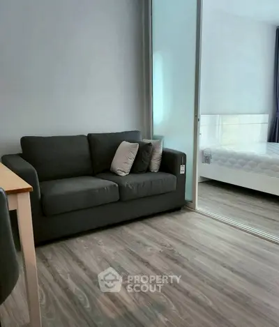 Modern apartment interior with cozy living room and adjacent bedroom