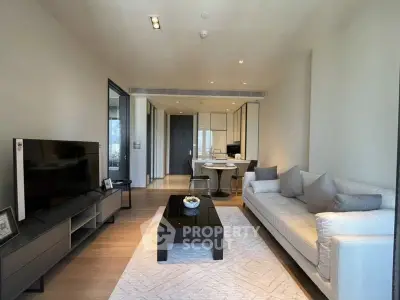 Modern living room with sleek furniture and open kitchen layout in a stylish apartment.