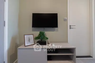 Modern living room corner with mounted TV and minimalist decor