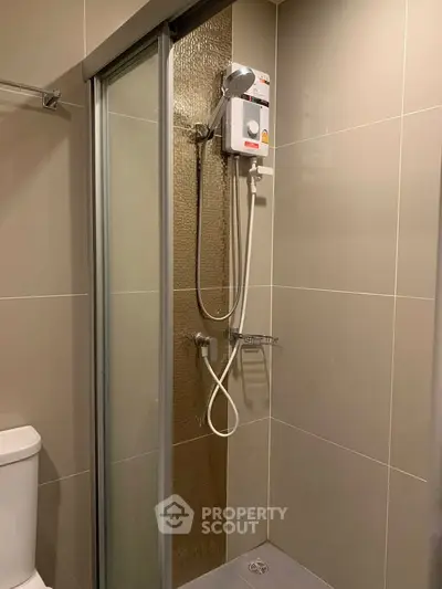 Modern bathroom with sleek shower enclosure and water heater