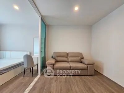 Modern living room with cozy sofa and sleek wooden flooring