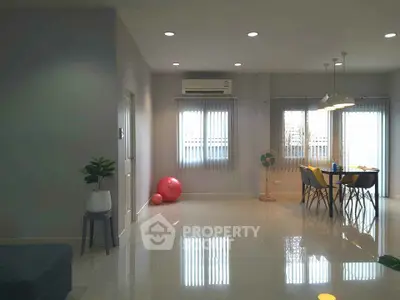 Spacious modern living room with dining area and natural light