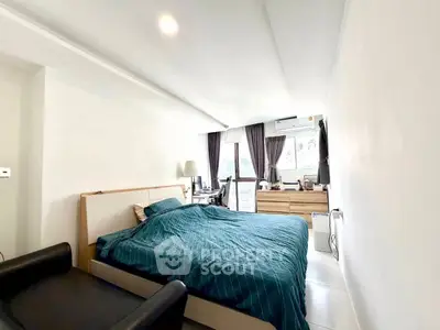 Spacious bedroom with modern decor and natural light