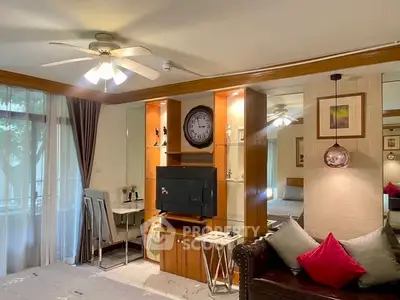 Charming living room with ceiling fan, cozy seating, and elegant decor, perfect for relaxation and entertainment.