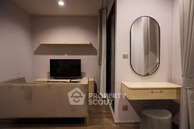 Modern living room with stylish furniture and wall-mounted TV