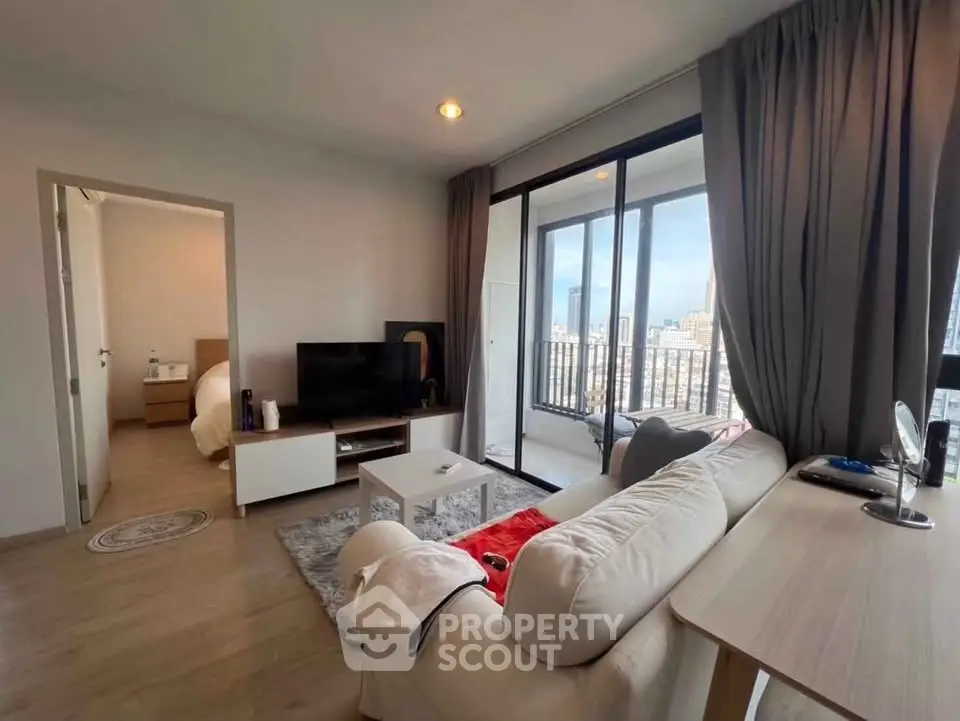 Modern living room with city view and balcony access in a stylish apartment.