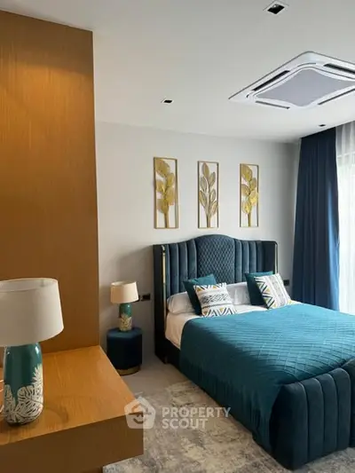 Luxurious bedroom with elegant decor and plush bedding in modern apartment.