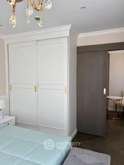 Elegant bedroom with sliding closet doors and modern decor