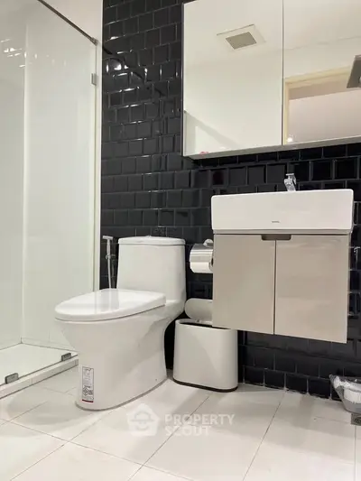 Modern bathroom with sleek black tiles and contemporary fixtures