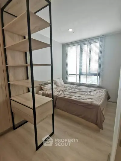 Modern bedroom with stylish shelving and large window for natural light