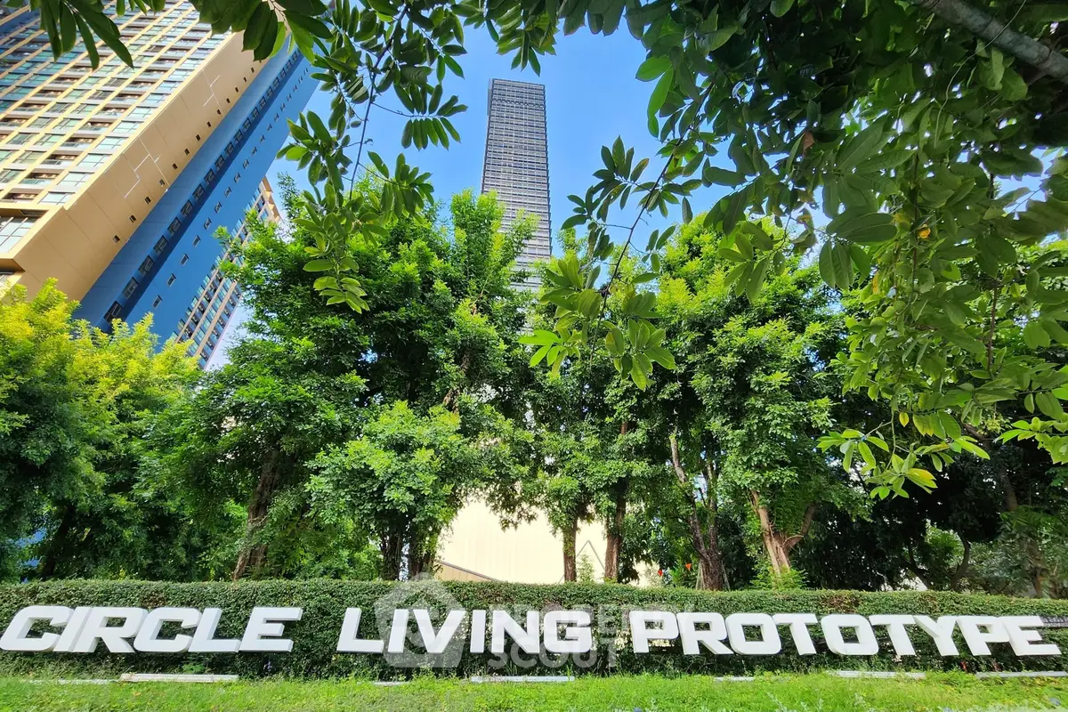 Modern high-rise building surrounded by lush greenery at Circle Living Prototype.