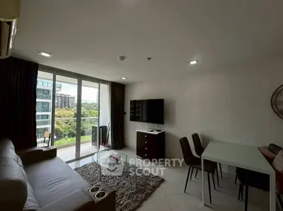 Modern living room with large windows and balcony view in a stylish apartment.