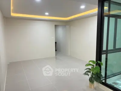 Modern empty room with sleek tile flooring and recessed lighting