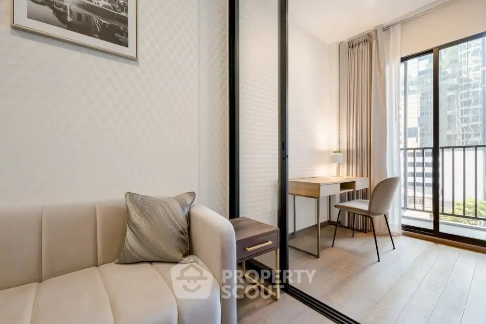 Modern living room with study area and balcony view in a stylish apartment.