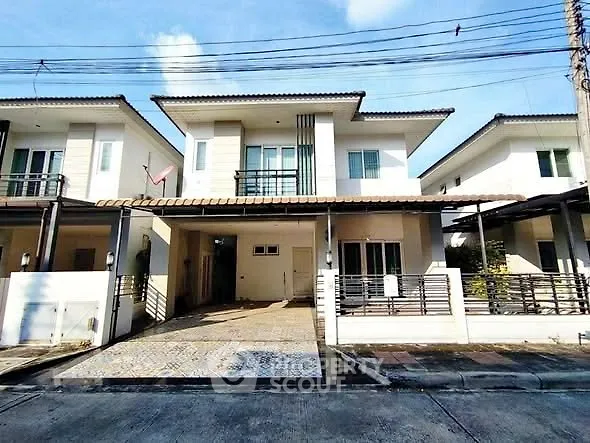 Modern two-story house with driveway and contemporary design in a suburban neighborhood.