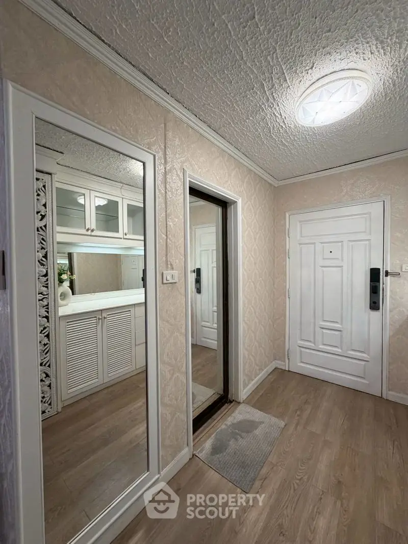 Charming entrance hallway with elegant mirror and modern decor
