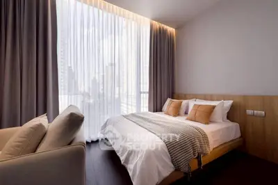 Modern bedroom with large window and city view, featuring cozy bed and elegant decor.