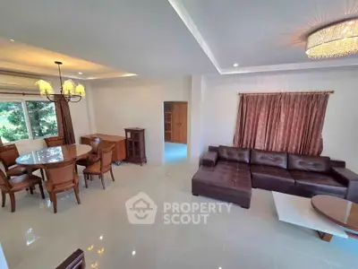 Spacious living room with elegant furniture and natural light, perfect for family gatherings.