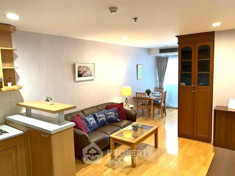 Spacious living room with wooden flooring and cozy furniture in modern apartment.