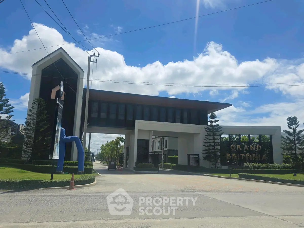 Grand Britannia entrance with modern architecture and lush landscaping
