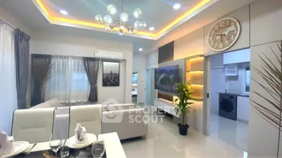 Modern living room with elegant lighting and open kitchen layout