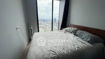 Modern bedroom with stunning city view from floor-to-ceiling windows