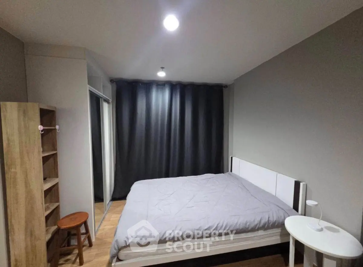 Modern bedroom with cozy bed and stylish decor in a contemporary apartment.