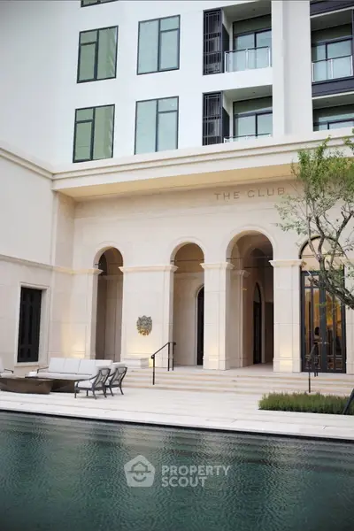 Luxurious building exterior with elegant poolside and modern architecture.