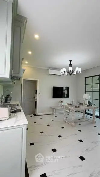 Elegant living room with modern chandelier and marble flooring