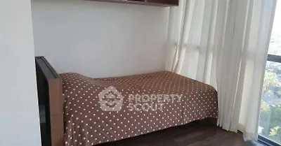 Cozy bedroom with large window and brown polka dot bedspread