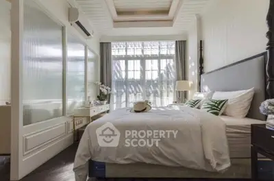 Elegant bedroom with natural light and stylish decor, featuring a cozy bed and modern furnishings.