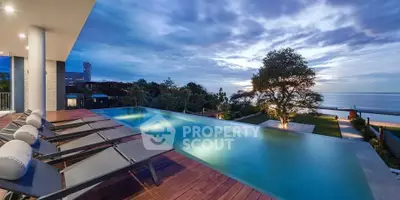 Luxurious infinity pool with stunning ocean view at sunset, perfect for relaxation and entertainment.