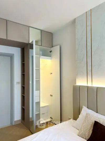 Modern bedroom with built-in wardrobe and elegant headboard
