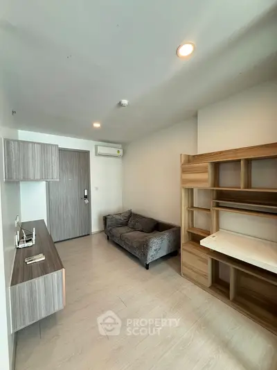 Modern living room with sleek furniture and wooden accents in a cozy apartment.