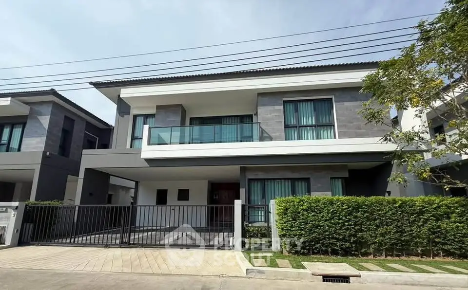 Modern two-story house with sleek design and spacious driveway in a serene neighborhood.