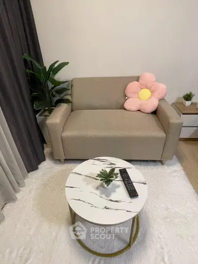 Cozy living room with stylish sofa and chic marble coffee table, perfect for modern urban living.