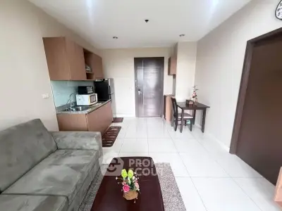 Modern living room with compact kitchen and cozy seating area