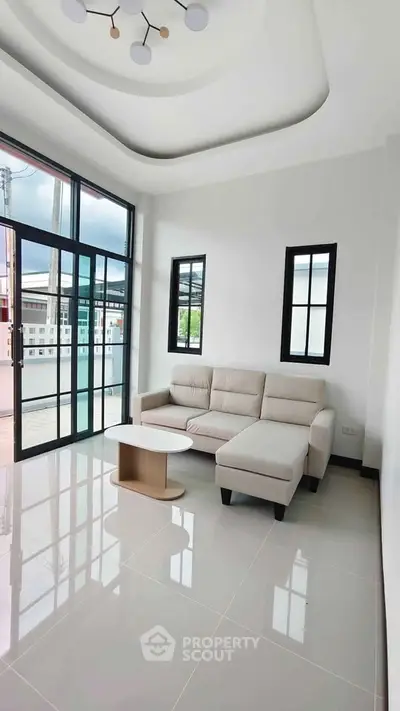 Modern living room with large windows and stylish ceiling design