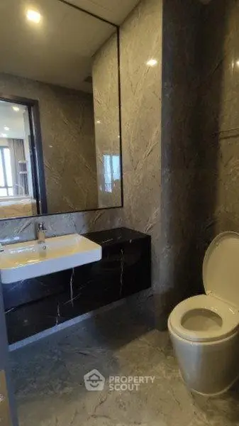 Luxurious modern bathroom with sleek marble finishes and elegant fixtures.