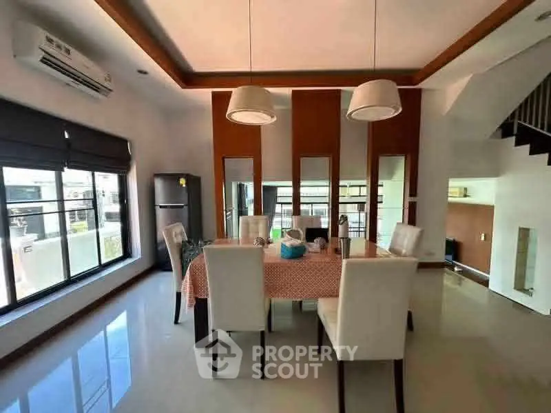 Modern dining area with elegant lighting and large windows